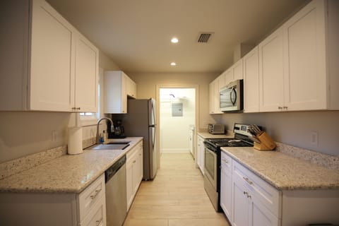 A view of the kitchen from the dining area. The laundry room is past the fridge.