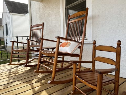 2 adult and one child sized rockers on the front porch