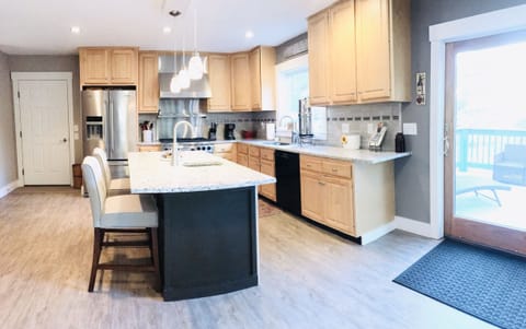 Spacious kitchen with breakfast island. Perfect for gathering!