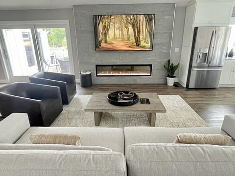 82" Smart TV, an extra large electric fireplace frame this amazing living room.