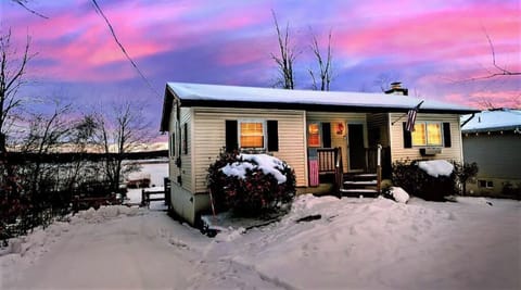 Street view of the front of the house with lake view and 3 car driveway