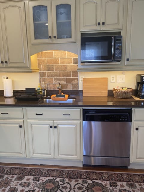 Brick accent backsplashes, dishwasher, microwave, pod/drip coffeepot. 