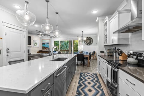 Gourmet kitchen features high end cabinets with Quartz countertops. Island seats 5.