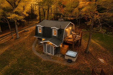 Soak in the hot tub right off the back door before heading up to the deck for some fresh air. Fall leaves cover the yard all around, and the whole place lights up warm once the sun goes down.