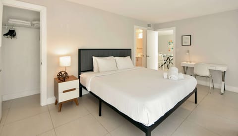 Spacious king bedroom with desk, closet, and open doorway