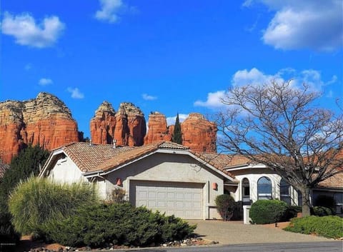 Thunder Mountain and Coffee Pot Rock stand behind the home.