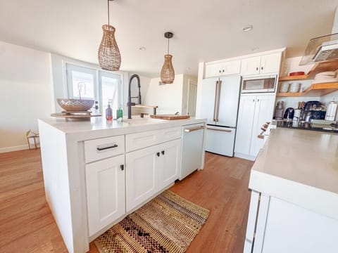 Step into our bright and inviting kitchen, featuring a spacious island with ample counter space for preparing meals