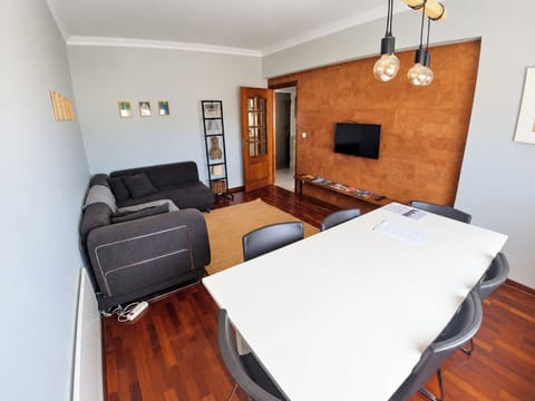 Spacious living and dining room with comfortable seating, a dining table and television.