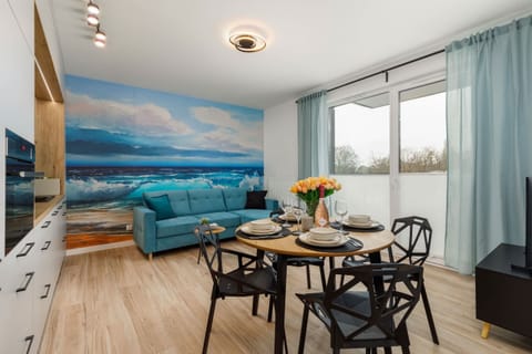 Another angle of the living and dining area showcasing an open, airy design.

