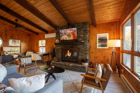 Unwind by the crackling wood-burning fireplace while soaking in panoramic views of Stratton Mountain.