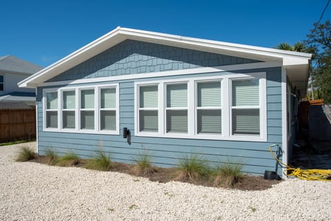 Front of home w/ brand new windows and a outdoor shower
