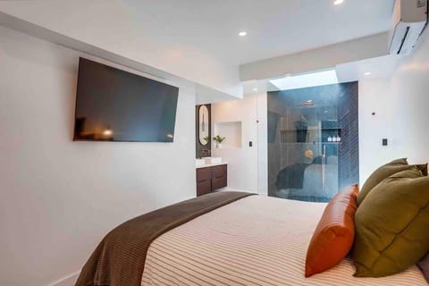 The bedroom also has a beautiful open shower and skylight. 