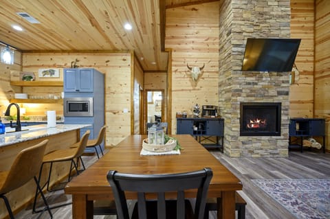 Gather, dine, and relax in one open-concept space with a cozy fireplace