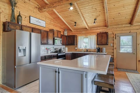 Spacious rustic kitchen with island seating and modern appliances for gatherings