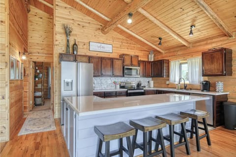 Spacious kitchen with island, modern appliances, and rustic cozy charm.