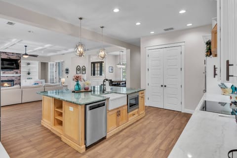 Gorgeous wood floors, perfect Farmhouse sink, coffee bar and endless other amenities in this gourmet kitchen to enjoy!