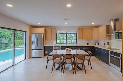 Beautiful fully equipped kitchen with view of the pool.