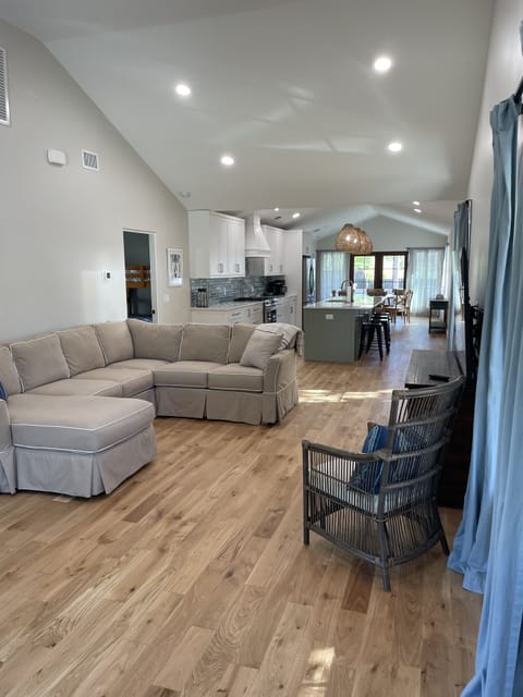 Living Room with vaulted ceilings, natural light, large smart TV.