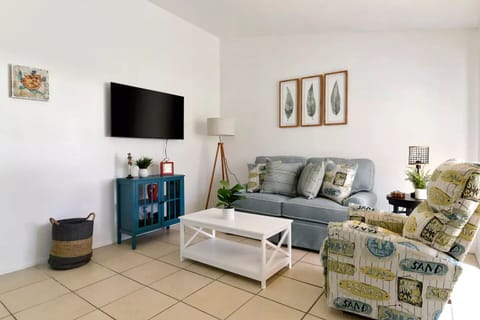 Cozy living room with sofa, recliner and Smart TV.