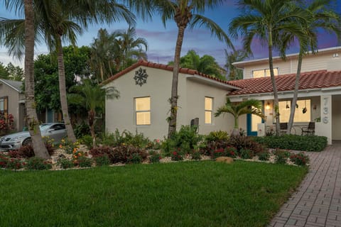 Enjoy walking up the three-car driveway.  with orchid lined palm trees
