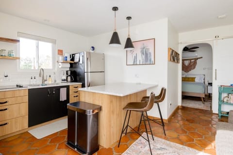 Casita kitchen with breakfast bar and full-size fridge for extra space.