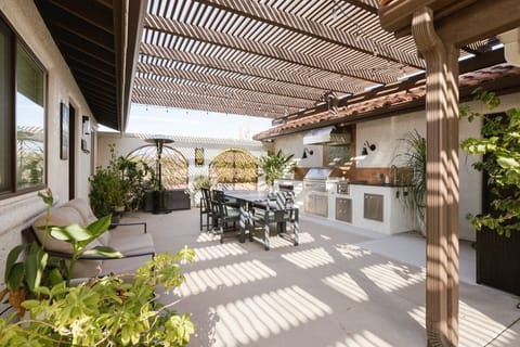 Covered outdoor living room flows from the kitchen to the dining area.