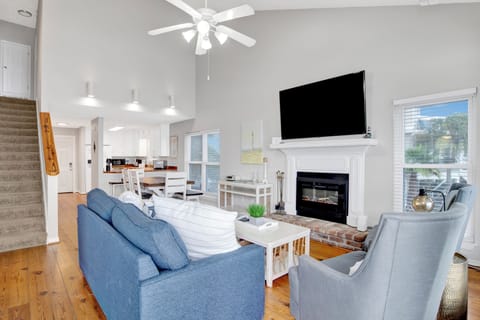 The living room offers balcony access and a sleeper sofa, sleeps 2