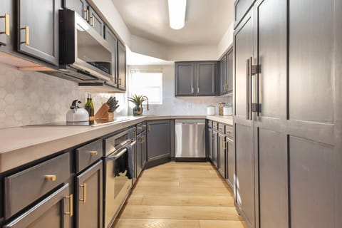 Kitchen with microwave, flattop stove/oven, dishwasher, Traditional coffee maker & utensils