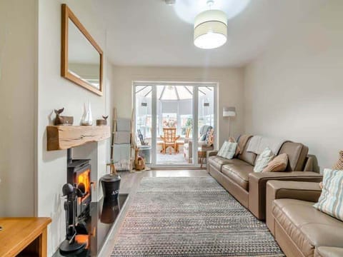 Spacious lounge with log burner, 3 seater & 2 seater large leather sofas
