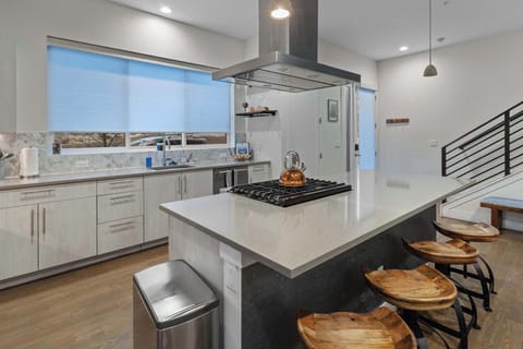 The spacious kitchen has plenty of appliances like a pressure cooker and electric kettle.