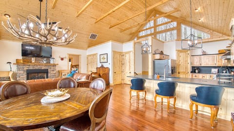 The open concept kitchen/dining room/living room with vaulted ceilings.