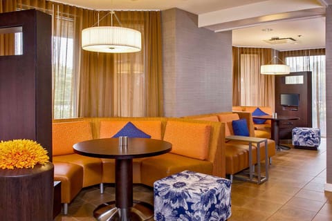 Linger in plush booth seating under soft, warm lighting.