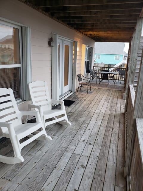 1st floor deck furnished with table and chairs and rockers