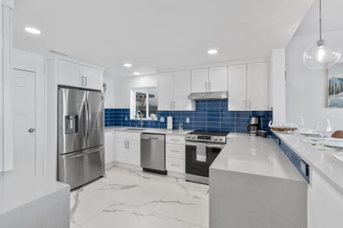large kitchen that is fully stocked with pots, pans, oil, and spices. 