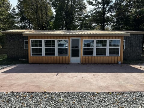Shared enclosed porch has 2 cafe' tables and chairs

