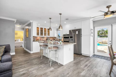 Beautifully updated kitchen with granite tops, shaker cabinetry, induction stove, 2 ovens, toaster oven, Keurig, and drip coffee maker. Service for 8!