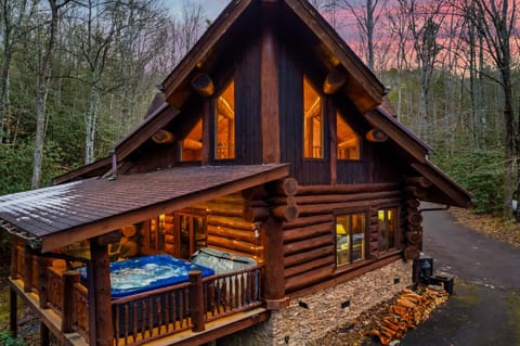 Private Smoky Mountain cabin glowing at twilight — your secluded Smoky Mountain escape