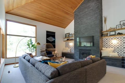 Large windows let in the light and look out on the surrounding birch trees