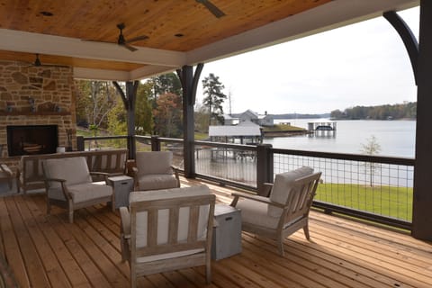 Porch seating with fireplace. There is a TV above fireplace, just not in picture