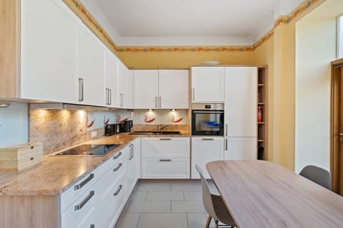 Fully equipped kitchen with modern appliances and plenty of space to cook and dine.