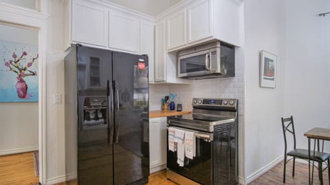 full kitchen with refrigerator, microwave, oven, dishwasher, etc