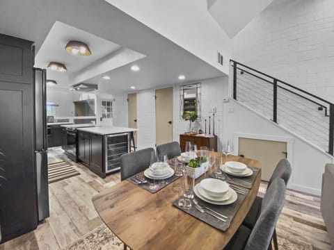 Enjoy meals and company in this modern, open-plan space. Features a stylish dining table and a fully-equipped kitchen with a wine fridge.