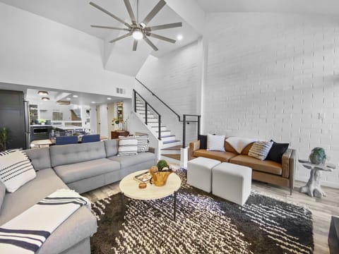 Relax in this cozy, modern living space. Features a warm fireplace, comfortable seating with sofa sleeper, and access to a patio. Perfect for unwinding.