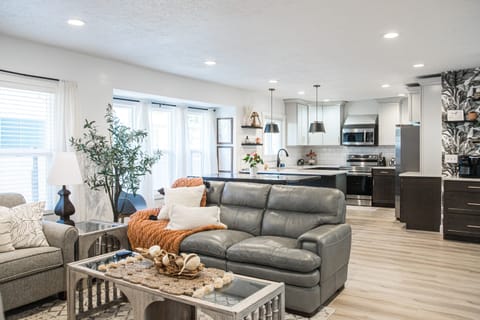 Relax on the La-Z-Boy leather couch enjoy the ambience of the colorful fireplace