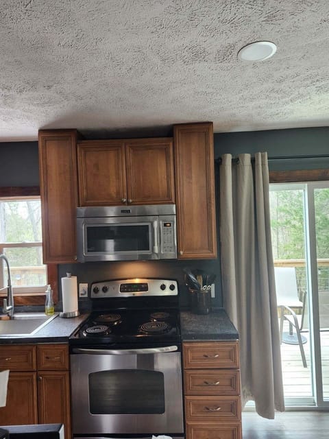 Stainless steel electric stove and full-size microwave.