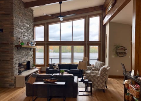 Living room of this modern timber frame lakehouse. Gather around the fireplace.