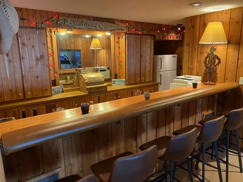 Bar area with running water and refrigerator seats six.
