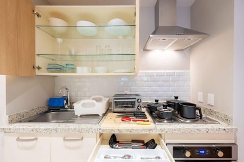 Fully equipped kitchen with appliances and utensils