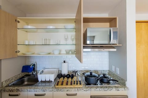 Fully equipped kitchen with appliances and utensils