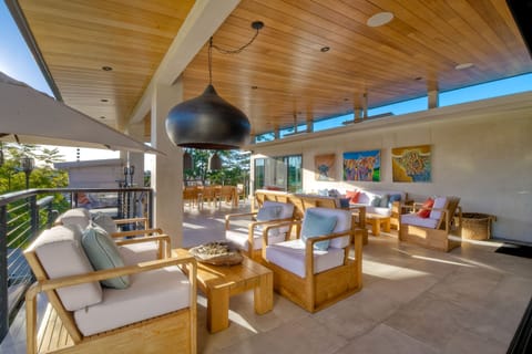 Private outdoor patio, comfortable couch seating for ten with 2 ten foot custom made couches and a 10 foot custom made teak table